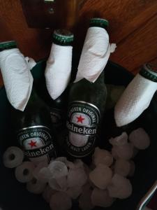 three bottles of beer in a bucket of popcorn at Pousada Recanto das Águas in Lumiar