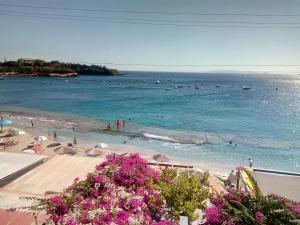 a view of a beach with people in the water at Buganvilla Sea View apts in Agia Pelagia