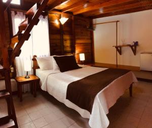 a bedroom with a large bed in a room with wooden ceilings at Cabañas Agua Dulce in Providencia