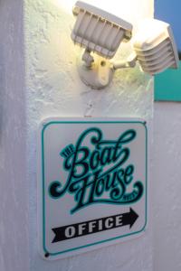 a sign for a boat house office attached to a wall at The BoatHouse in Marco Island