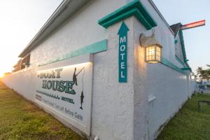 a building with a sign on the side of it at The BoatHouse in Marco Island