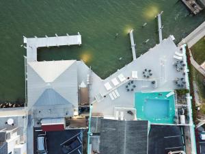 an overhead view of a large white building next to the water at The BoatHouse in Marco Island