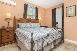 a bedroom with a bed and a window at The BoatHouse in Marco Island