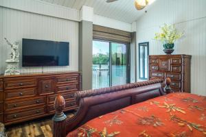 a bedroom with a flat screen tv and a bed at The BoatHouse in Marco Island