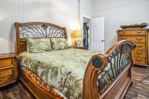 a bedroom with a wooden bed and a dresser at The BoatHouse in Marco Island