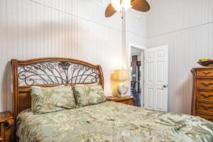 a bedroom with a bed and a lamp and a dresser at The BoatHouse in Marco Island