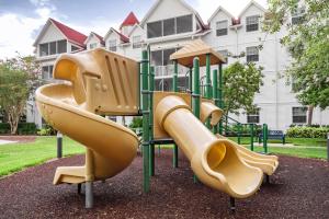 a playground with slides in front of a building at Grand Beach Resort in Orlando