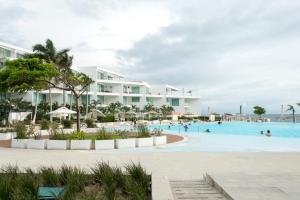 a view of the pool at a resort at RESTYLE: Ocean front + pool Nuevo Vallarta in Nuevo Vallarta