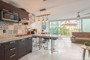 a kitchen with a large island in a room at RESTYLE: Ocean front + pool Nuevo Vallarta in Nuevo Vallarta