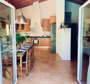 a kitchen with a table and a refrigerator at Endless Summer Surf House in Aljezur