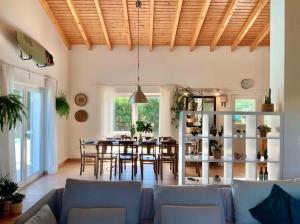 a living room with a table and a dining room at Endless Summer Surf House in Aljezur