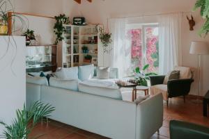 a living room with a couch and a table at Endless Summer Surf House in Aljezur