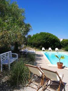 a couple of chairs and a swimming pool at Endless Summer Surf House in Aljezur
