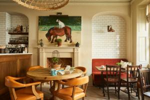 a living room with a horse statue on the wall at Lime Tree Hotel in London