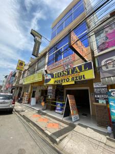 a store on the side of a street at Hostal Puerto Azul in Manta