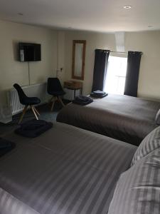 Ένα ή περισσότερα κρεβάτια σε δωμάτιο στο Red Lion Rooms - Self Check In