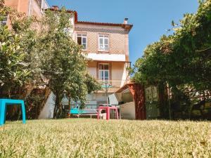 
a lawn chair sits in front of a house at Urban Garden Porto Central Hostel in Porto
