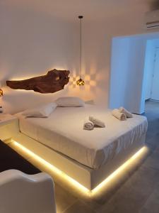 een slaapkamer met een groot bed met een lamp erop bij Eternal Suites in Mykonos-stad