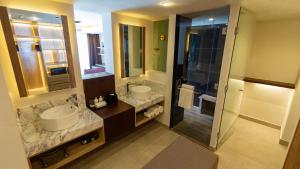a bathroom with two sinks and a walk in shower at Armar House, All-Inclusive in Cancún