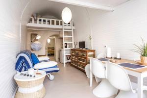 a bedroom with a bunk bed and a desk and chairs at Chalaris Armeni Villa in Oia