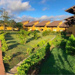 a house with a garden in front of it at Winterville Resort em Gravatá/PE in Gravatá