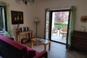 a living room with a door open to a patio at Stunning 2 Bed Apartment, Outside Terrace, Sleeps 4 in Villa Latina