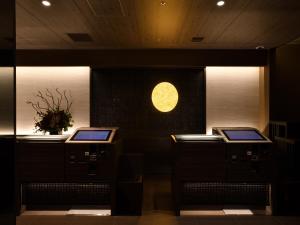 a room with two counters and a clock on the wall at Hotel Keihan Sendai in Sendai
