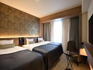 Postel nebo postele na pokoji v ubytování Hotel Keihan Sendai + 37 fotografií