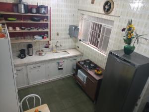 a small kitchen with a stove and a refrigerator at São Paulo Wanderlust G Hostel in São Paulo