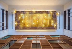a room with a chandelier on the wall at Icon Saigon - LifeStyle Design Hotel in Ho Chi Minh City