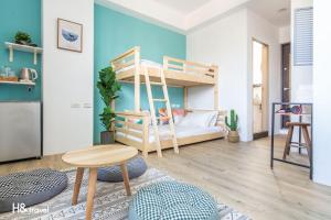 a living room with a bunk bed and a table at Sleepier Multi-Minsu Tainan in Tainan