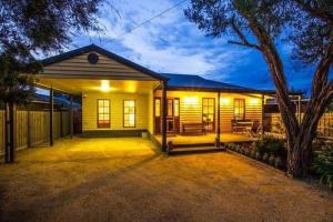 a house with a lit up front of it at Charmes, paradise by the shore in Tootgarook