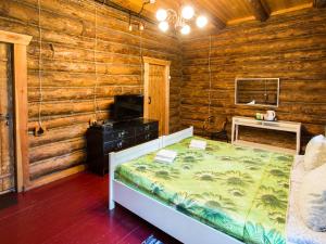 a bedroom with a bed in a log cabin at Park Hotel Berendeevka in Kostroma