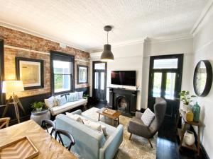 a living room with a couch and a fireplace at Hollidge House 5 Star Luxury Apartments in Adelaide