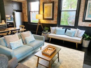 a living room with two couches and a table at Hollidge House 5 Star Luxury Apartments in Adelaide