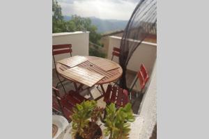 a wooden table and chairs on a balcony at Kasakarma in Agira