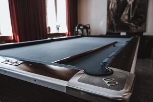 a pool table with a cue on top of it at Ferienwohnung Grischuna in Bivio
