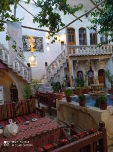 a building with a staircase and tables and chairs at ŞarkÇırağan Konak Boutique Hotel in Sanlıurfa