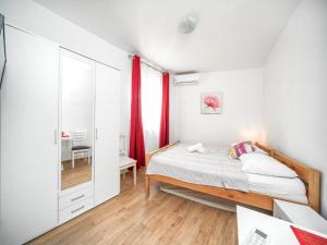 a bedroom with a bed and a mirror at Apartments Matija in Vodice