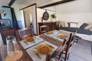 a dining room with a table and chairs at Gîte Le Balcon Flaubert in Forges-les-Eaux