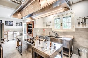 a kitchen with a sink and a stove at Alfresco luxury Villa with Heated pool in Montecatini Terme