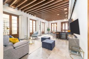 a living room with a couch and a table at iloftmalaga Premium Calle Nueva in Málaga