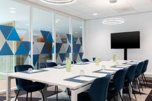 a conference room with a long table and chairs at Holiday Inn Express Amsterdam - North Riverside by IHG in Amsterdam