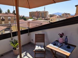a balcony with a table and a view of a city at Relais Monti Apartments in Vallo della Lucania