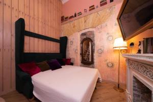 a bedroom with a white bed and a fireplace at Трирівневий лофт із спальнею-укриттям SELF Check-in 247 in Odesa