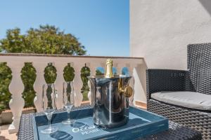 a table with two wine glasses and a silver pitcher at Apartment Astoria in Zaton