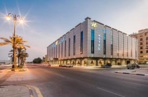 a large building on a city street with a road at Naviti Warwick Al Khobar in Al Khobar