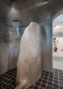 a room with a concrete wall and a potted plant at Petra Residence Mini Pool Spa in Adamas