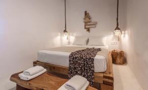 a bedroom with a bed with two towels on it at Petra Residence Mini Pool Spa in Adamas