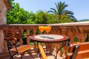 a table with a glass of orange juice on it at Finca Ca's Curial - Agroturismo - Adults Only in Sóller